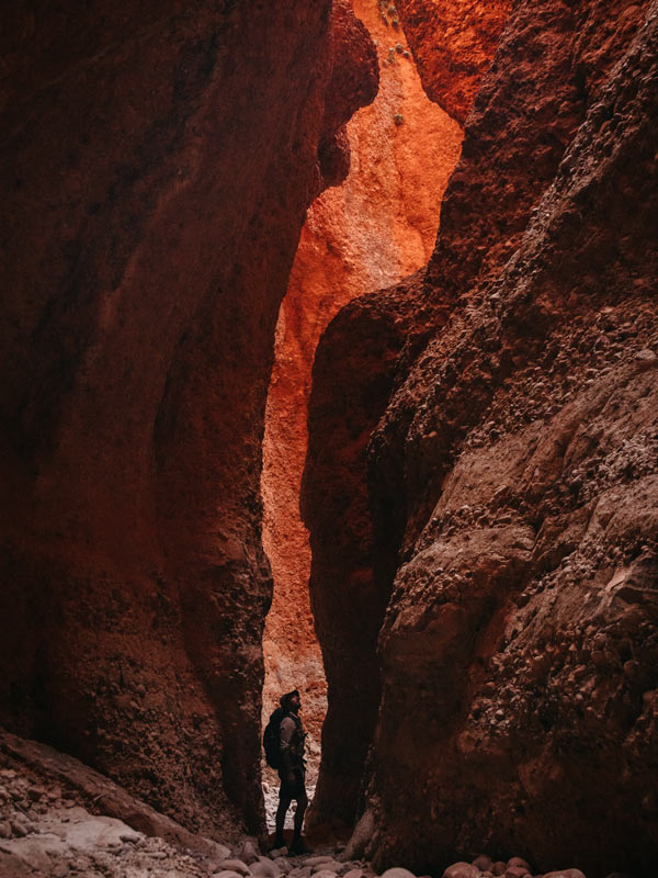 a person standing between the red walls at Echidna Chasm