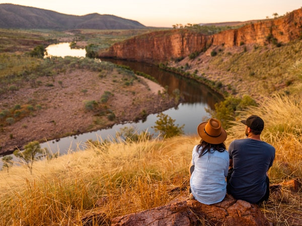 a couple on top of a grassy land at El Questro Wilderness Park, Kimberley