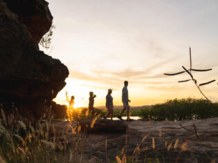 people walking at sunset during Kakadu Cultural Tours