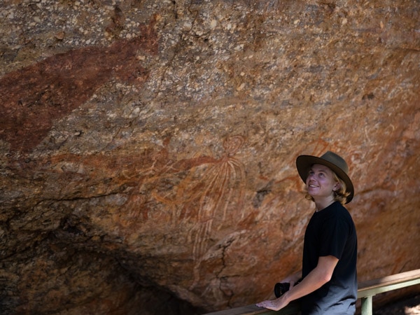 a woman admiring the rock art in Kakadu National Park