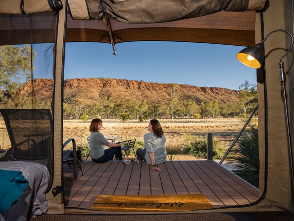 two women sitting and talking outside the luxury eco-tent at Squeaky Windmill