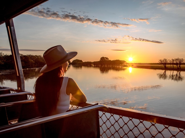 a woman admiring the sunset on a Yellow Water Cruise in Kakadu