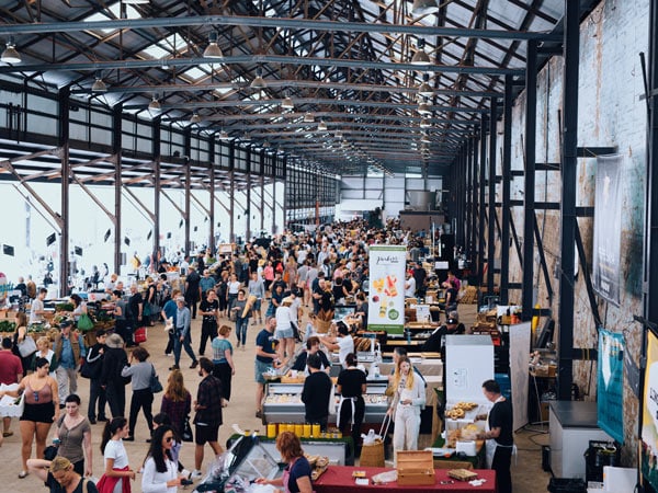 a wide shot of Carriageworks Farmers Markets filled with shoppers