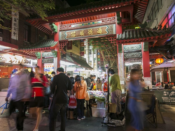 a crowd of people strolling around Chinatown Markets