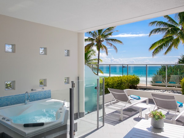 a balcony with sun loungers at On The Beach Noosa Resort