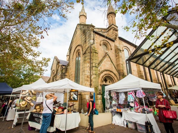 the bustling shopping stalls at Paddington Markets beside the Paddington Uniting Church