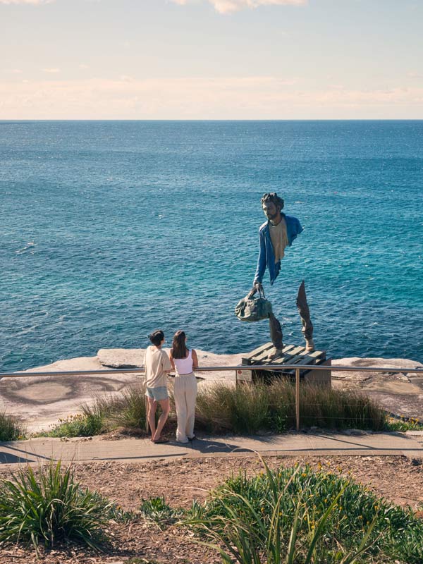 Couple enjoying the Sculpture by the Sea, Bondi to Tamarama coastal walk at Marks Park, Tamarama