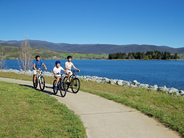 a family biking along Lake Jindabyne, Snowy Mountains