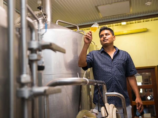 a guy holding a cold brew at Matso’s Brewery & Restaurant, Broome