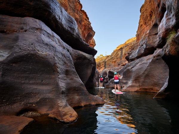 stand-up paddling amidst sandstone formations at Cobbold Gorge