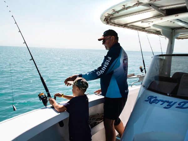 a father and son fishing at Karumba