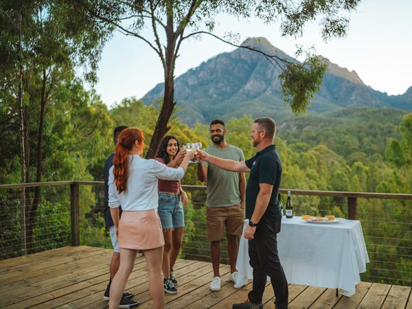 A group of people celebrate amongst the beauty of Scenic Rim in Southeast Queensland.