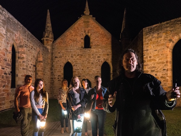 A tour guide takes people through a Ghost Tour at Port Arthur Historic Site. (Image: Alastair Bett)