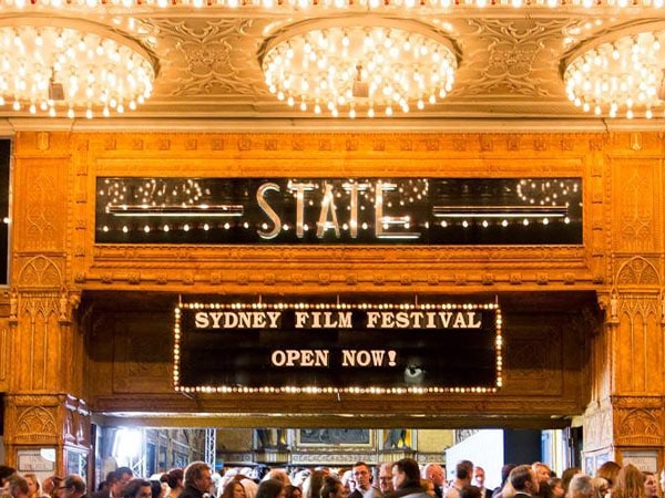 Outside Sydney's State Theatre, a sign says Sydney Film Festival Open Now! (Image: Sydney Film festival)