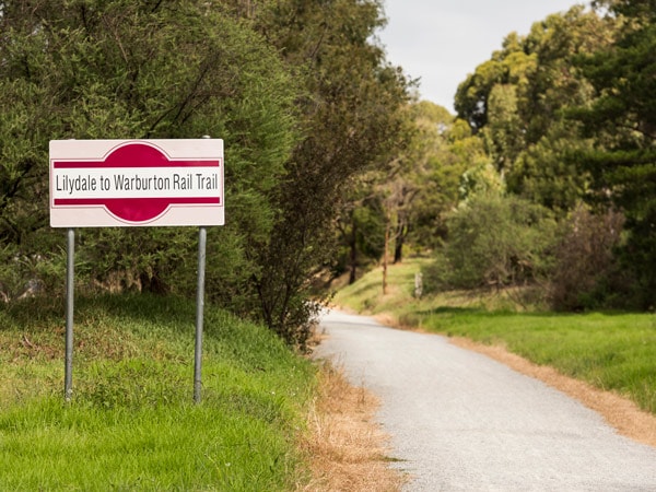 A photo of a red and white sign on a road.