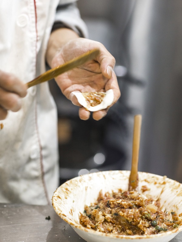 a chef preparing a dumpling mixture at CBD Dumpling House