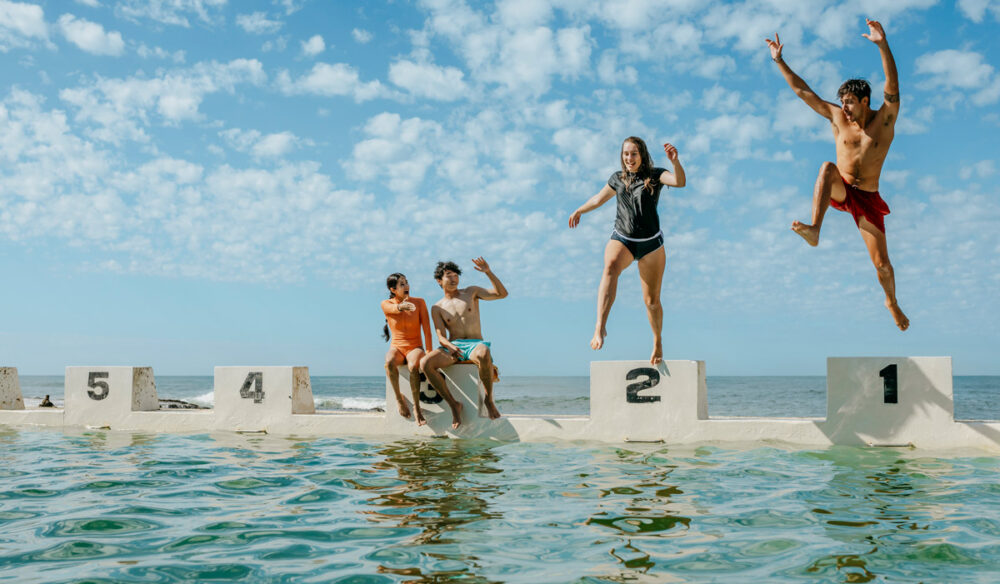 teens jumping into the water at Merewether Ocean Baths