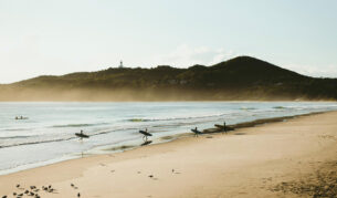 surfers at sunrise on Belongil Beach, Byron Bay