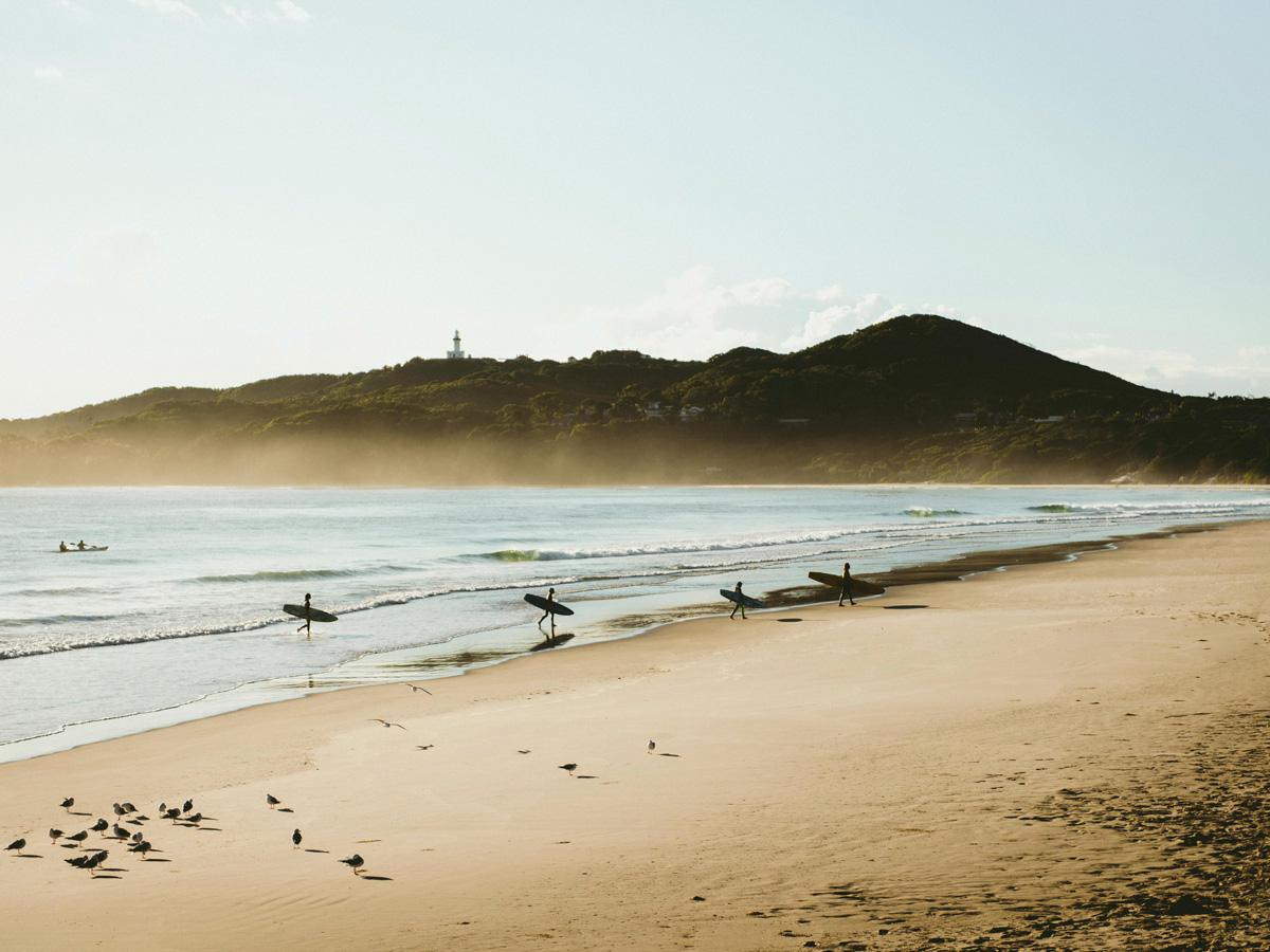 surfers at sunrise on Belongil Beach, Byron Bay