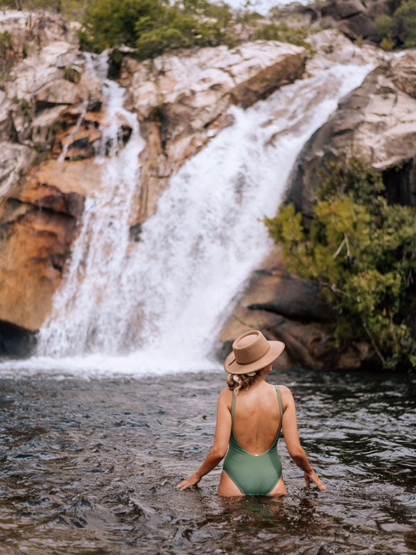 a girl dipping in the Emerald Creek Falls, Cairns