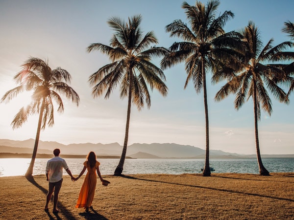 a couple strolling along the beach in Port Douglas