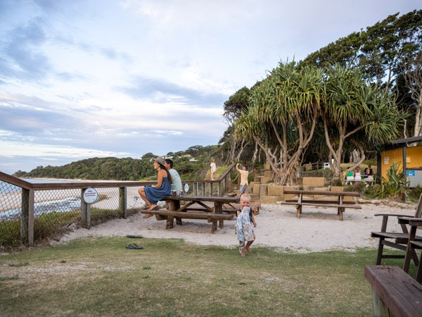 a family with a small child on the campground of Reflections Byron Bay