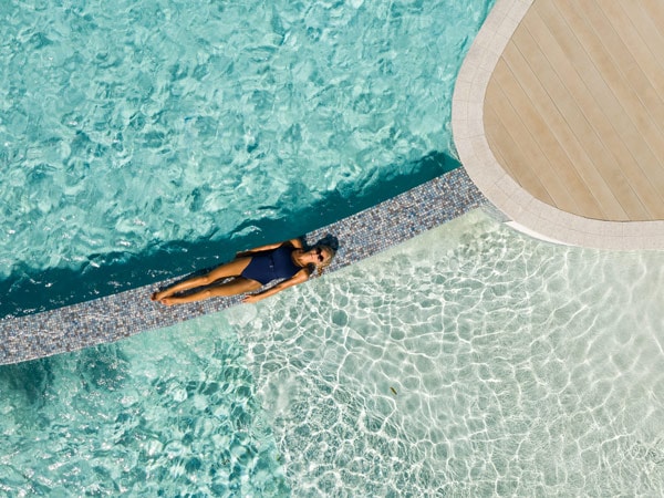 a top view of a woman relaxing on the pool at Crystalbrook Riley