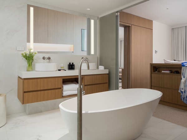 a suite bathroom with a tub at Crystalbrook Riley