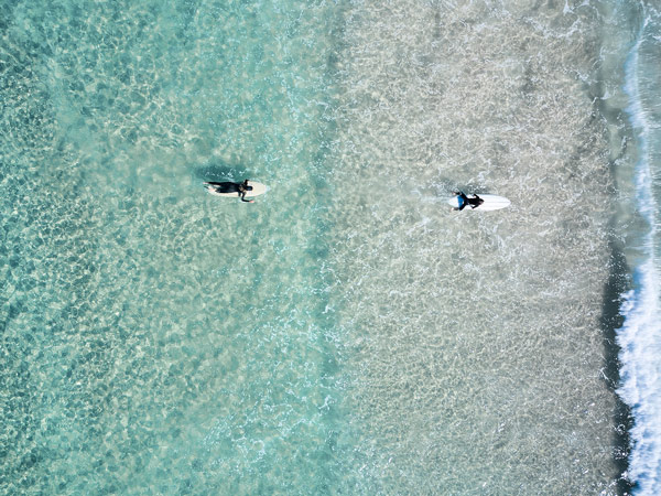 surfers at The Pass, Byron Bay