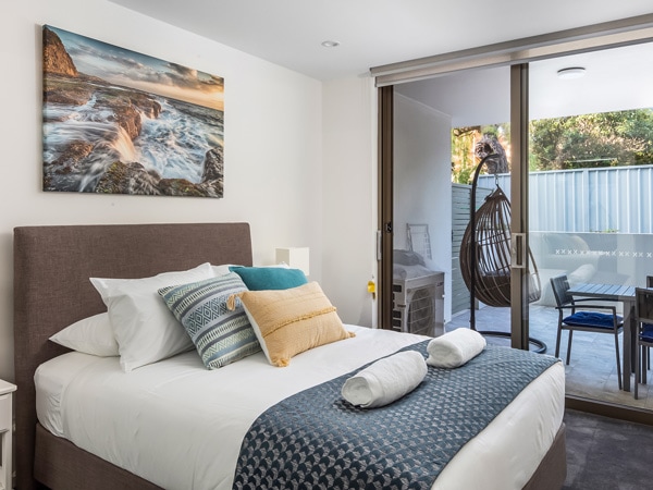 the bedroom with an outdoor deck at Bluewater Apartments, Kiama