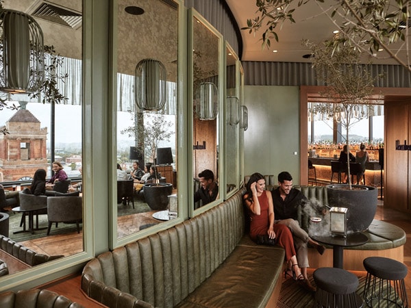 a couple sitting at the Crystalbrook Kingsley Romberg's Cocktails Booth
