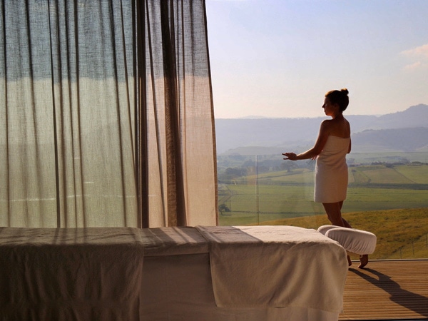 a woman in her robe admiring the scenic landscape at Dovecote