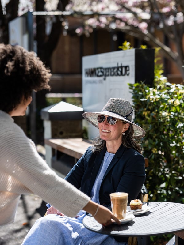 a staff at Hawkes General Store serving coffee to a customer