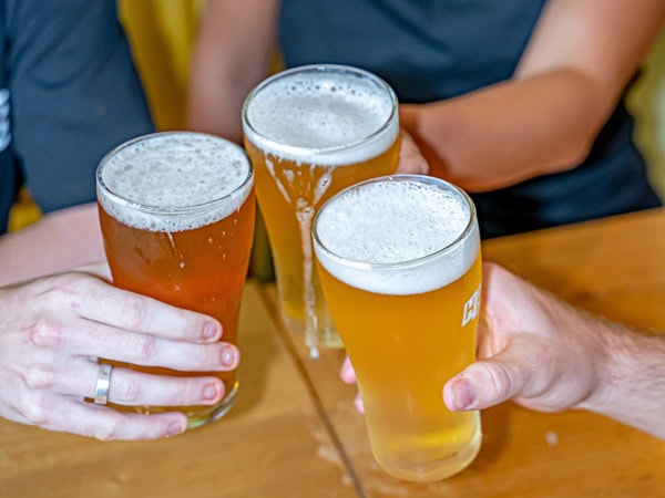 hands clinking beer glasses at His Boy Elroy