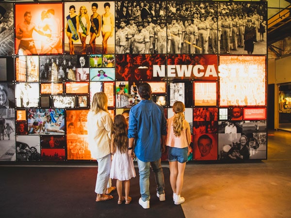 a family looking at the gallery display inside Newcastle Museum