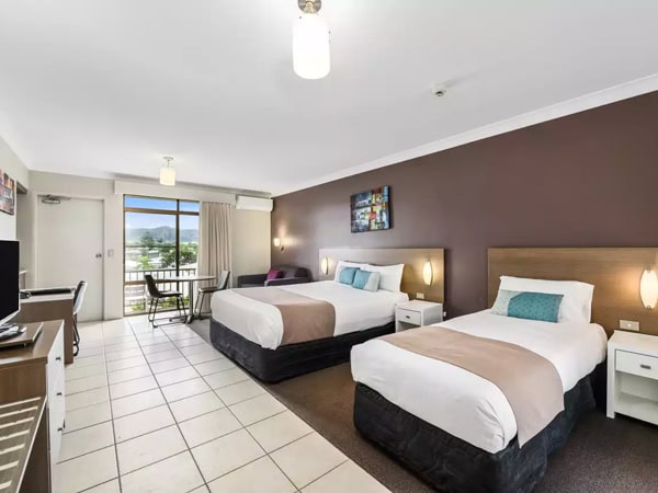 the bedroom with two beds and a balcony at Quality Hotel City Centre, Coffs Harbour