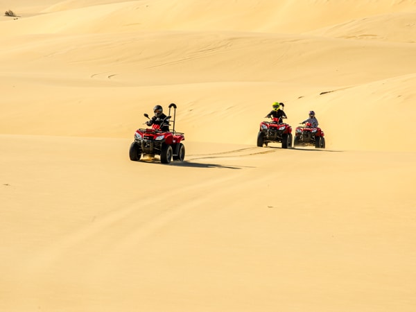 people enjoying the quad bike tour at Stockton Sand Dunes