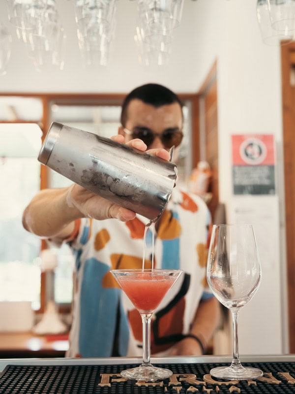 a bartender pouring cocktail into the glass at Stef Beachstone, Coffs Harbour