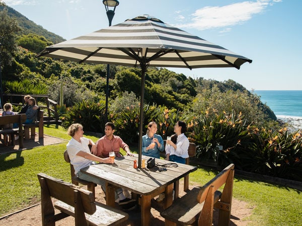 friends drinking al fresco under an umbrella at The Scarborough Hotel