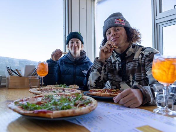 two people eating pizza at Eagles Nest, Thredbo