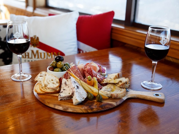 a grazing board shared platter with two glasses of wine at Kareela Hutte