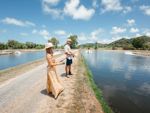 a couple fishing in the Daintree, Hook-a-Barra farm tour, Port Douglas