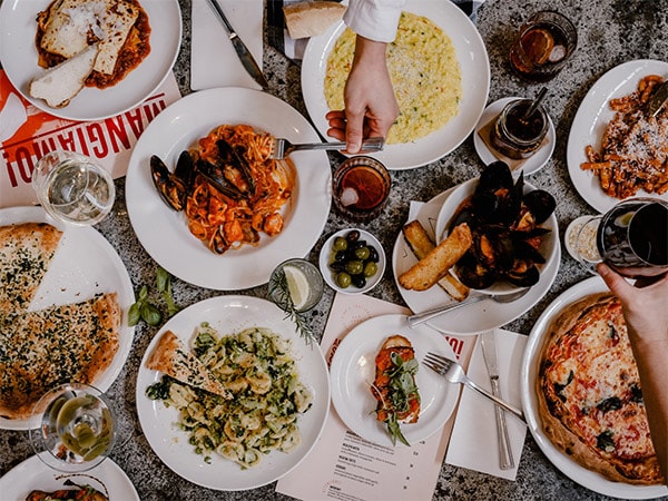 Table of pizza and pasta at Pino's Phillip Island