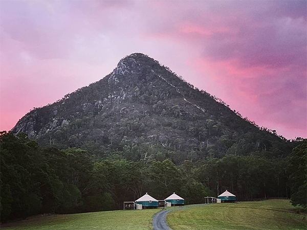 Noosa Eco Retreat set among a mountainous sunset