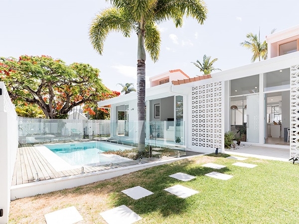 Pool and palm trees at Poincana House