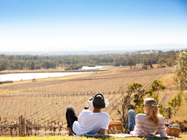 two people sitting on the grass while admiring the landscape at Audrey Wilkinson