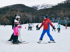 a family learning how to ski with an instructor at Thredbo in the Snowy Mountains