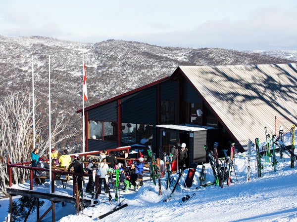 people gathering around the outdoor deck at Kareela Hutte, Thredbo