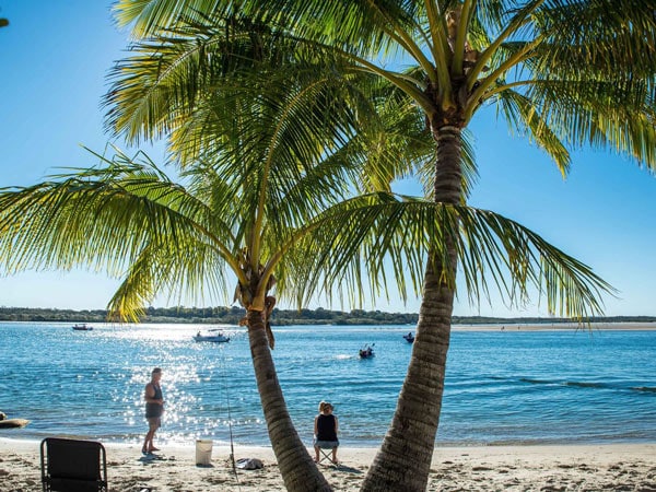 two people on the beach at Noosa River Holiday Park