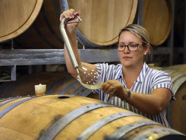 a woman pouring wine from the barrel at First Creek, Hunter Valley